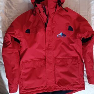The iconic Abercrombie & Kent expedition red winter coat with blue lining.